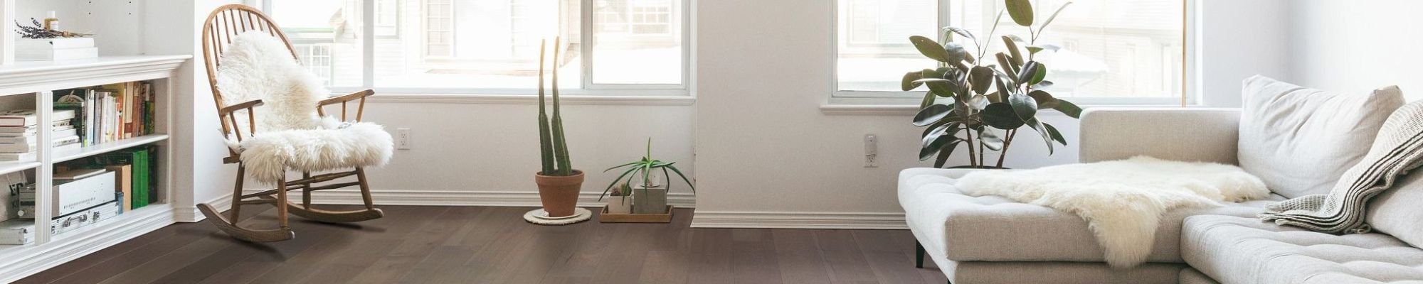 white couch on brown hardwood floor from Midstates Flooring Center LLC. in Brookings, SD